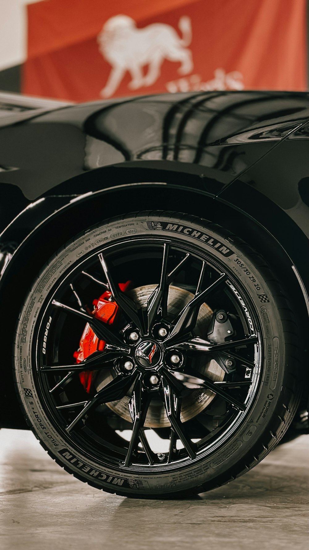 a close up of a black sports car tire