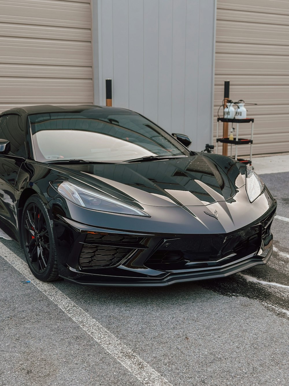 a black sports car parked in a parking lot