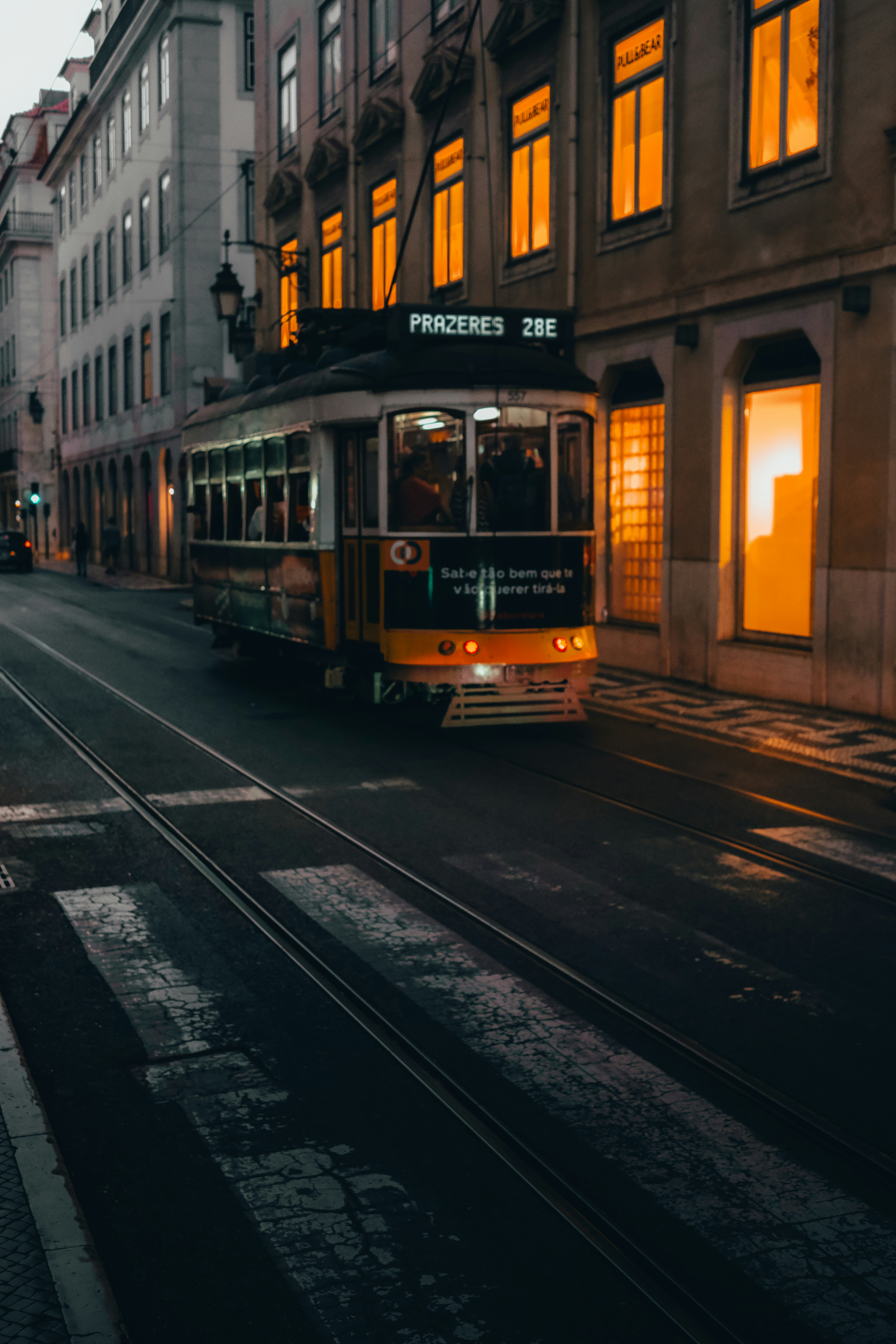 a trolley is going down a city street