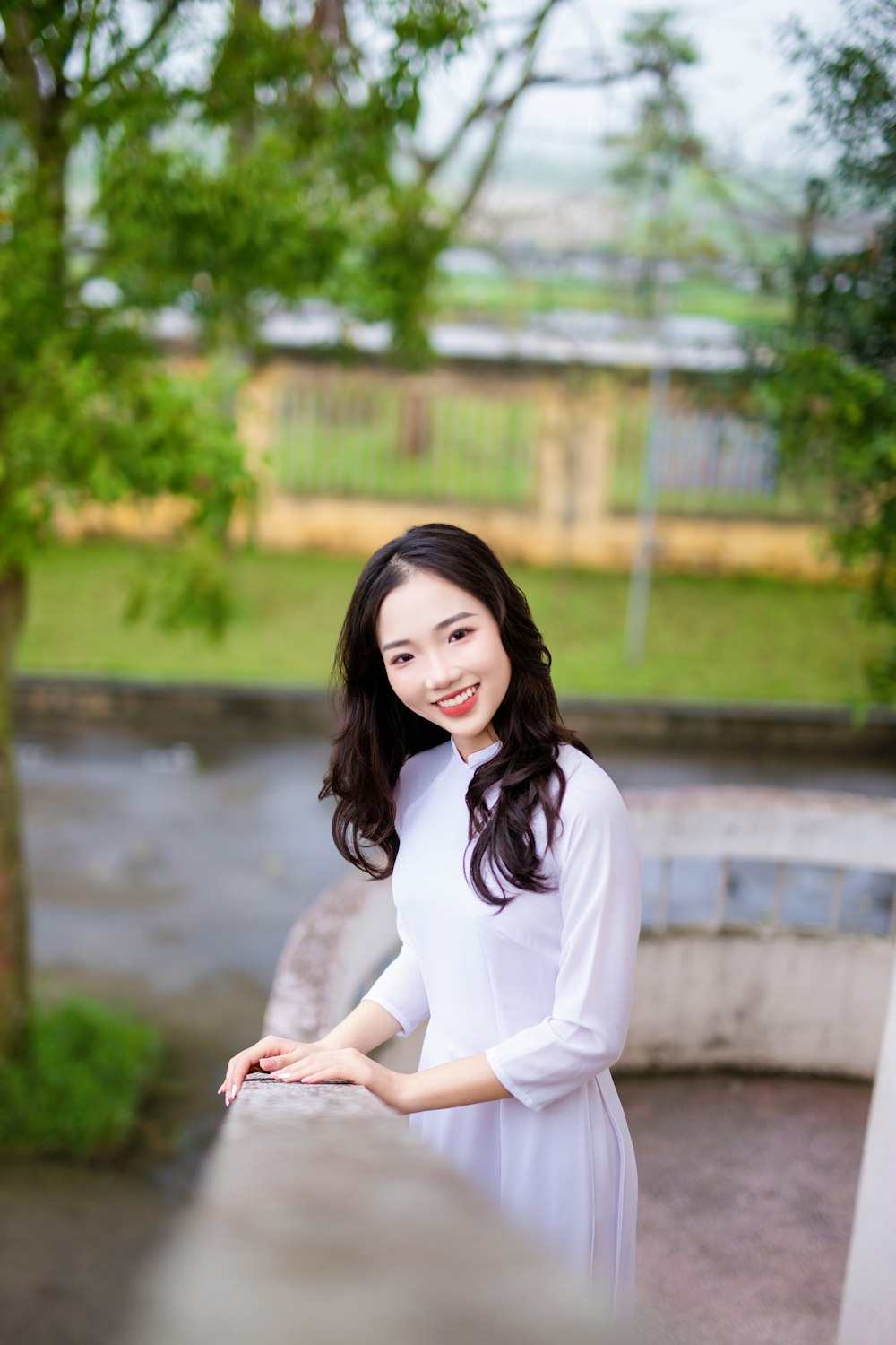 a woman in a white dress posing for a picture