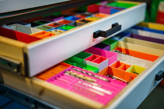 a close up of a drawer with many different colored drawers