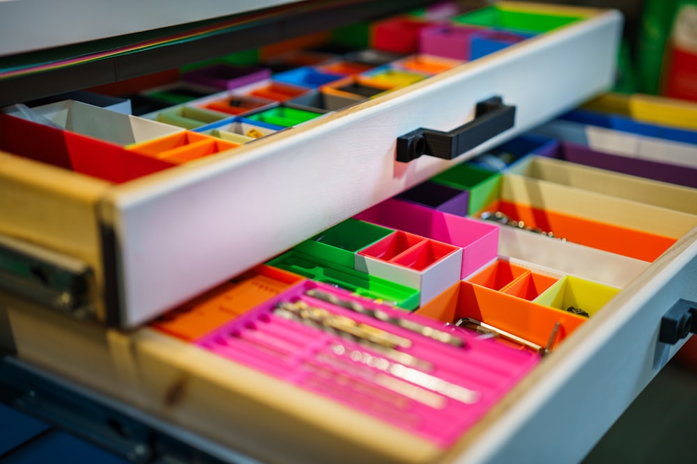 a close up of a drawer with many different colored drawers