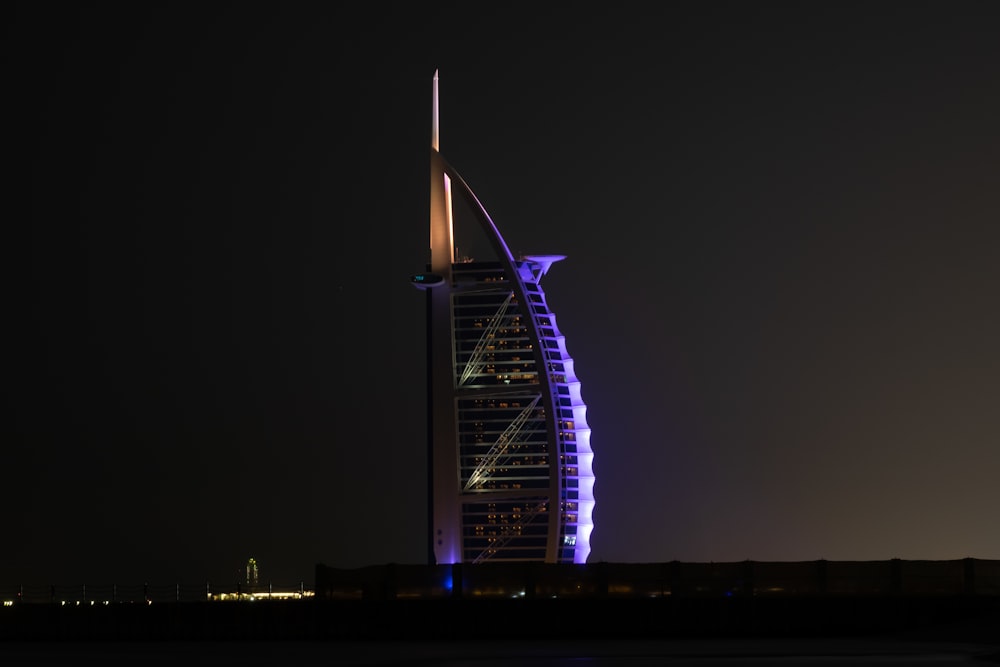 a tall building lit up in the night sky