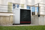 a white air conditioner sitting in front of a building
