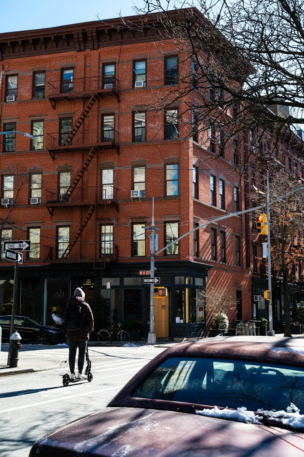 a man riding a skateboard down a street next to a tall building