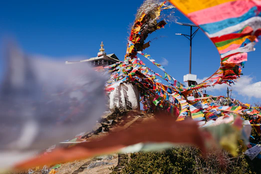 a group of colorful flags blowing in the wind