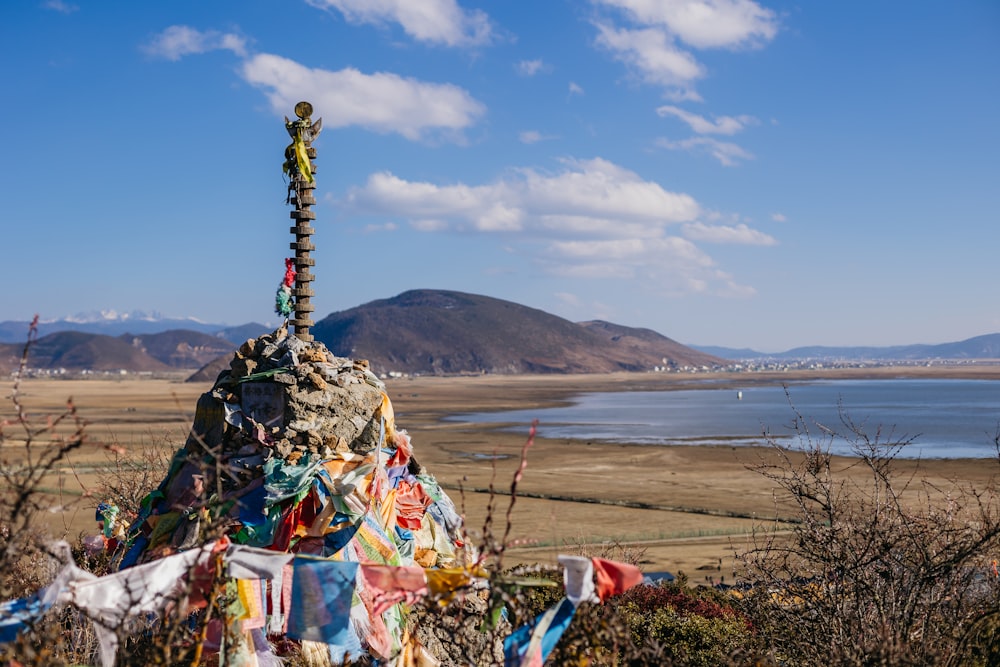 a rock tower with a man standing on top of it