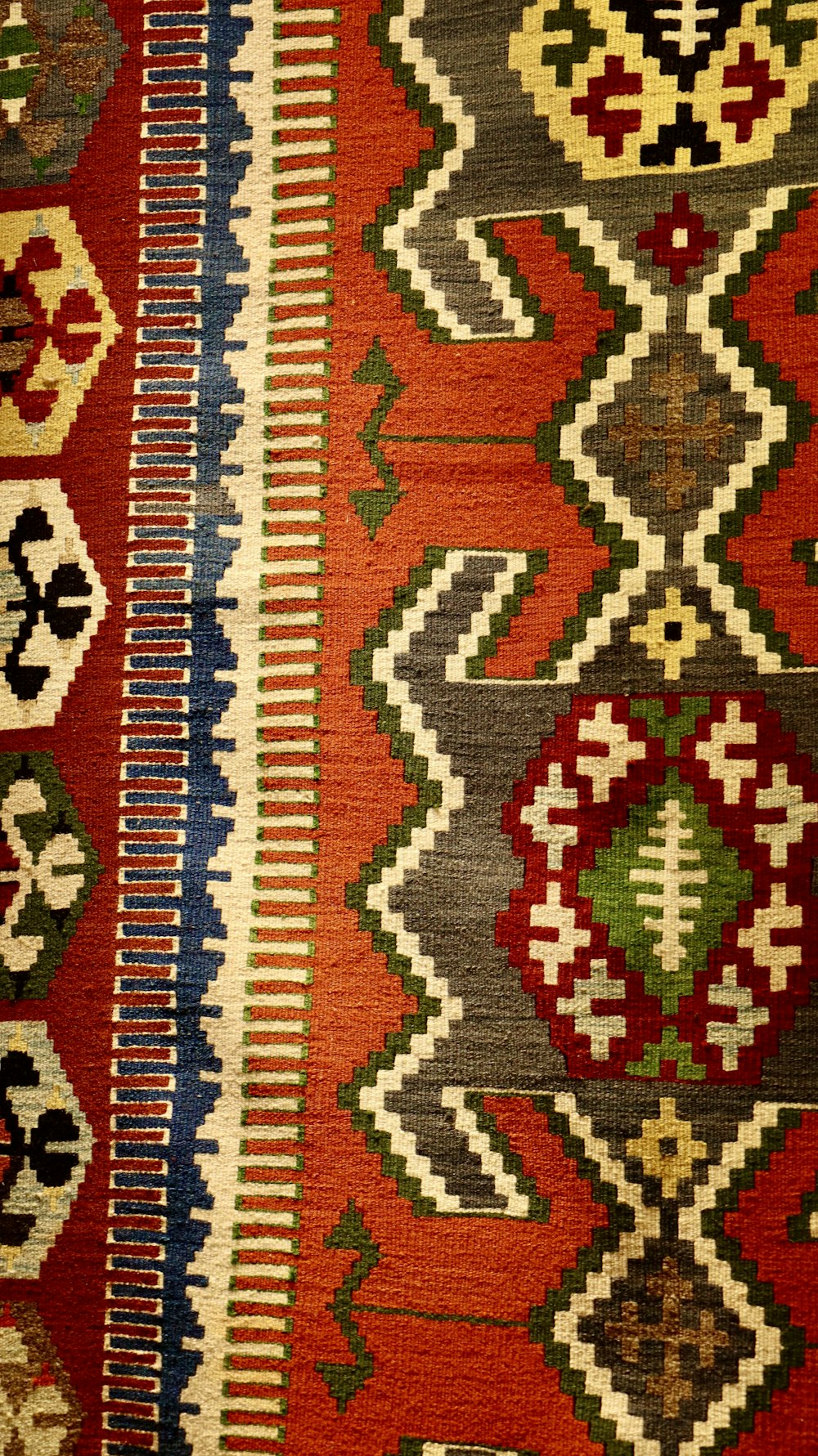 a close up of a red and black rug