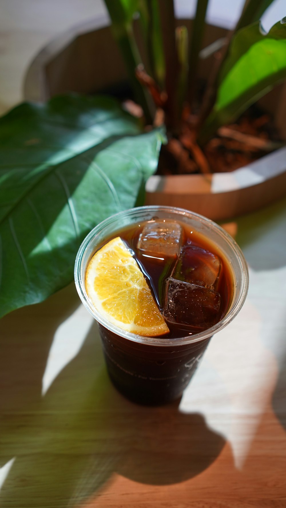 a cup of iced tea with a slice of orange