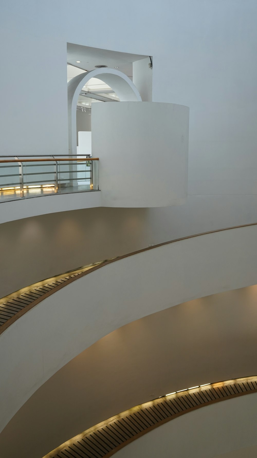 a white building with a spiral design and a balcony