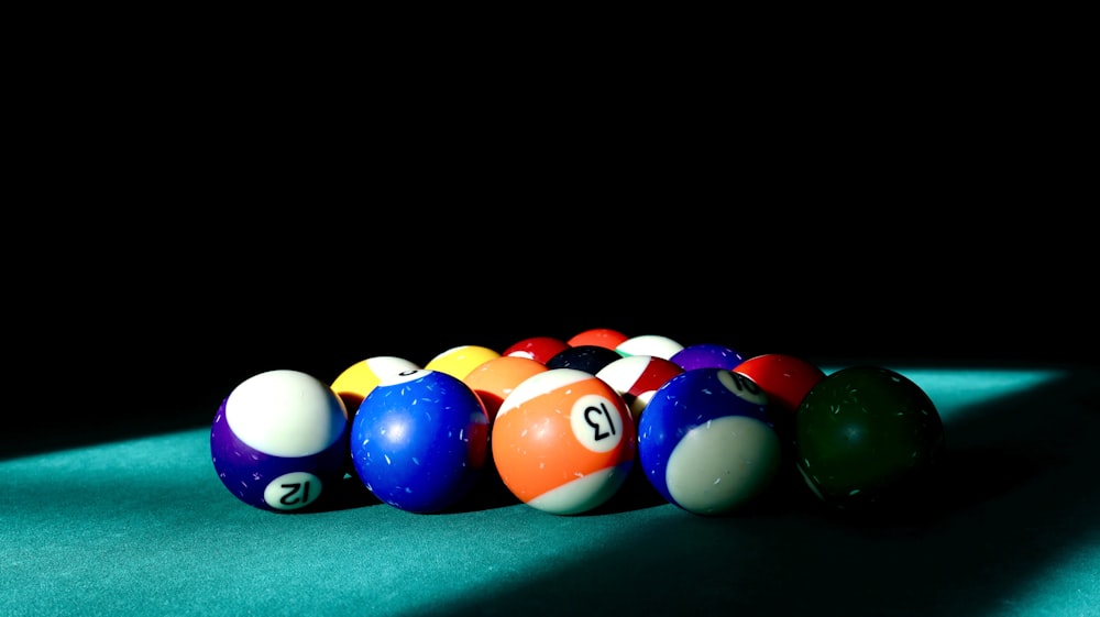 a row of pool balls sitting on top of a pool table