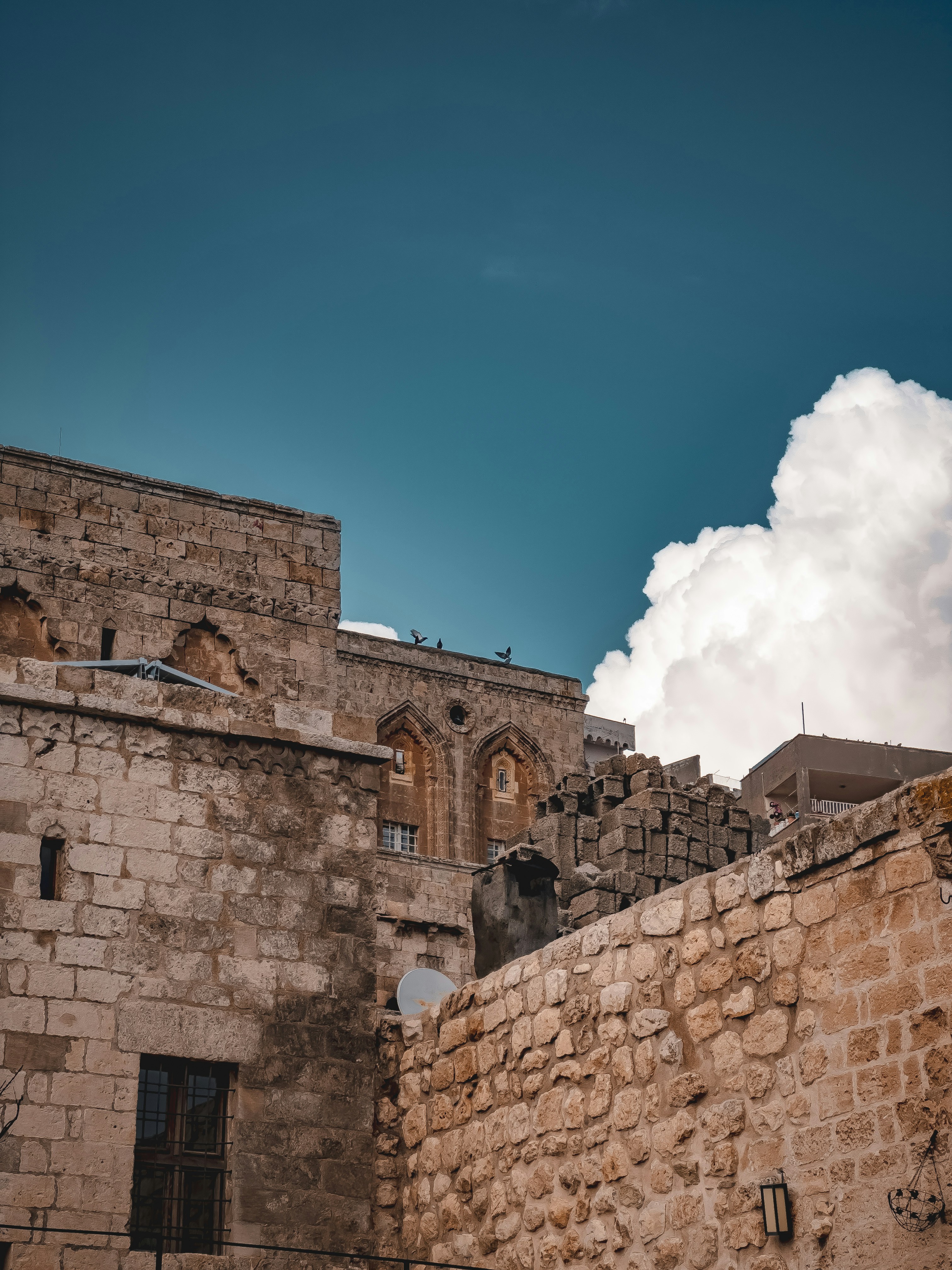 a stone building with a clock on the side of it