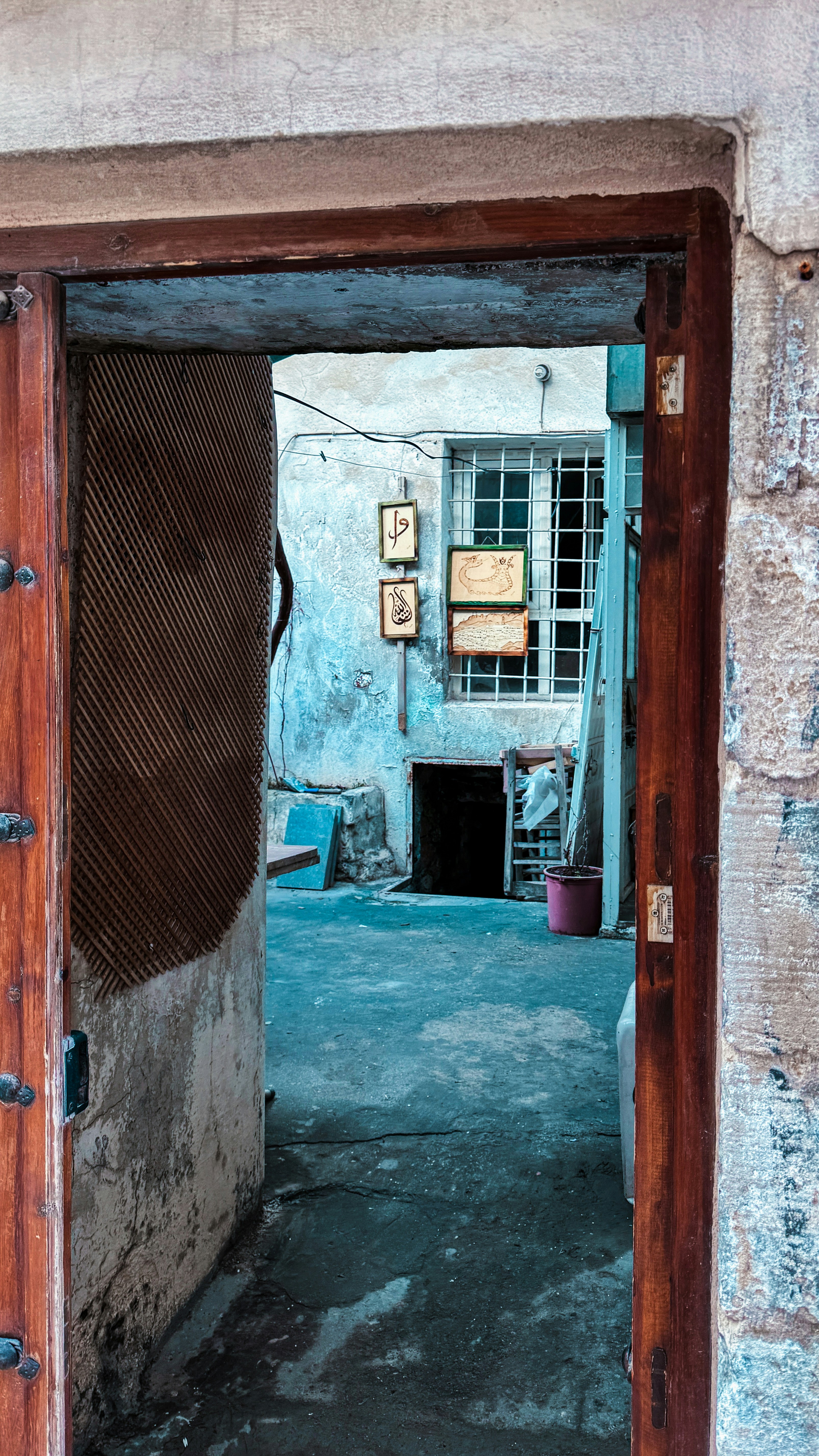 an open door leading to a building with a sign on it