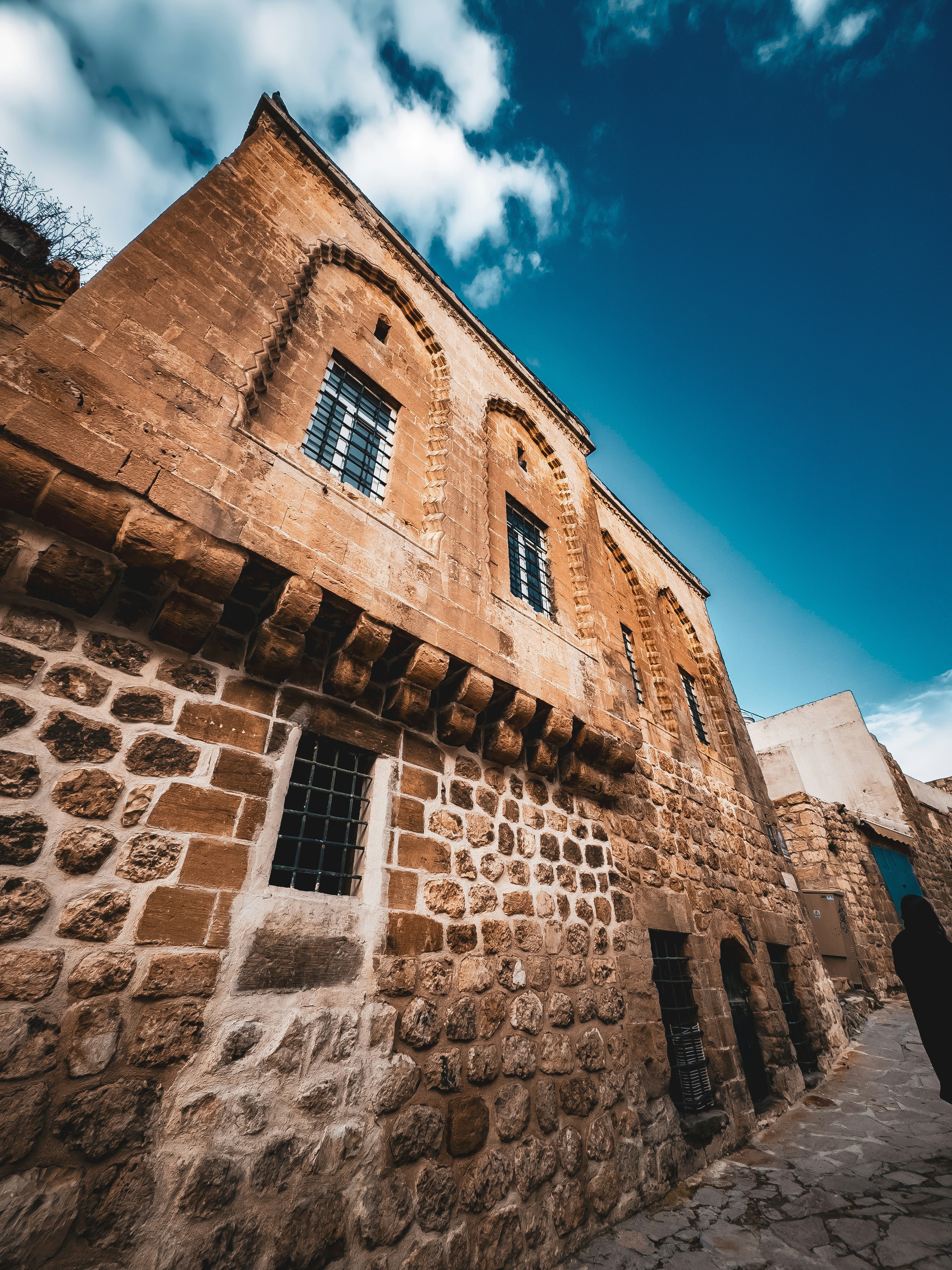 a stone building with a sky background