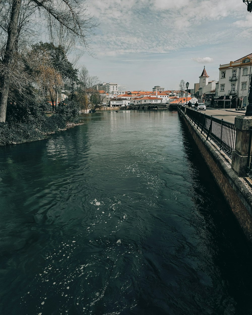 a body of water with buildings in the background