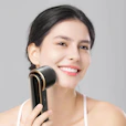 a woman holding a hair dryer in her hand