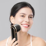 a woman holding a hair dryer in her hand