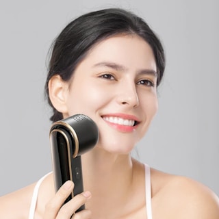 a woman holding a hair dryer in her hand