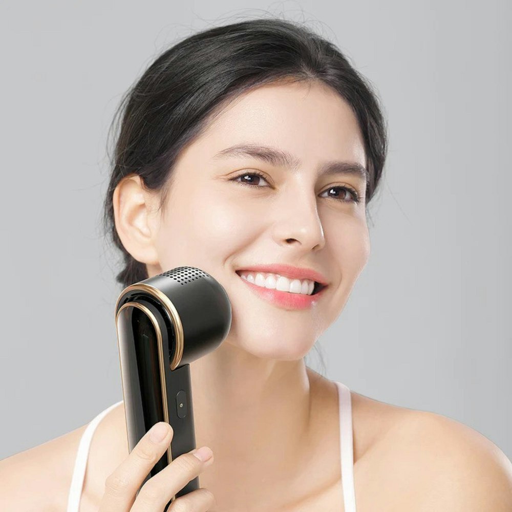 a woman holding a hair dryer in her hand