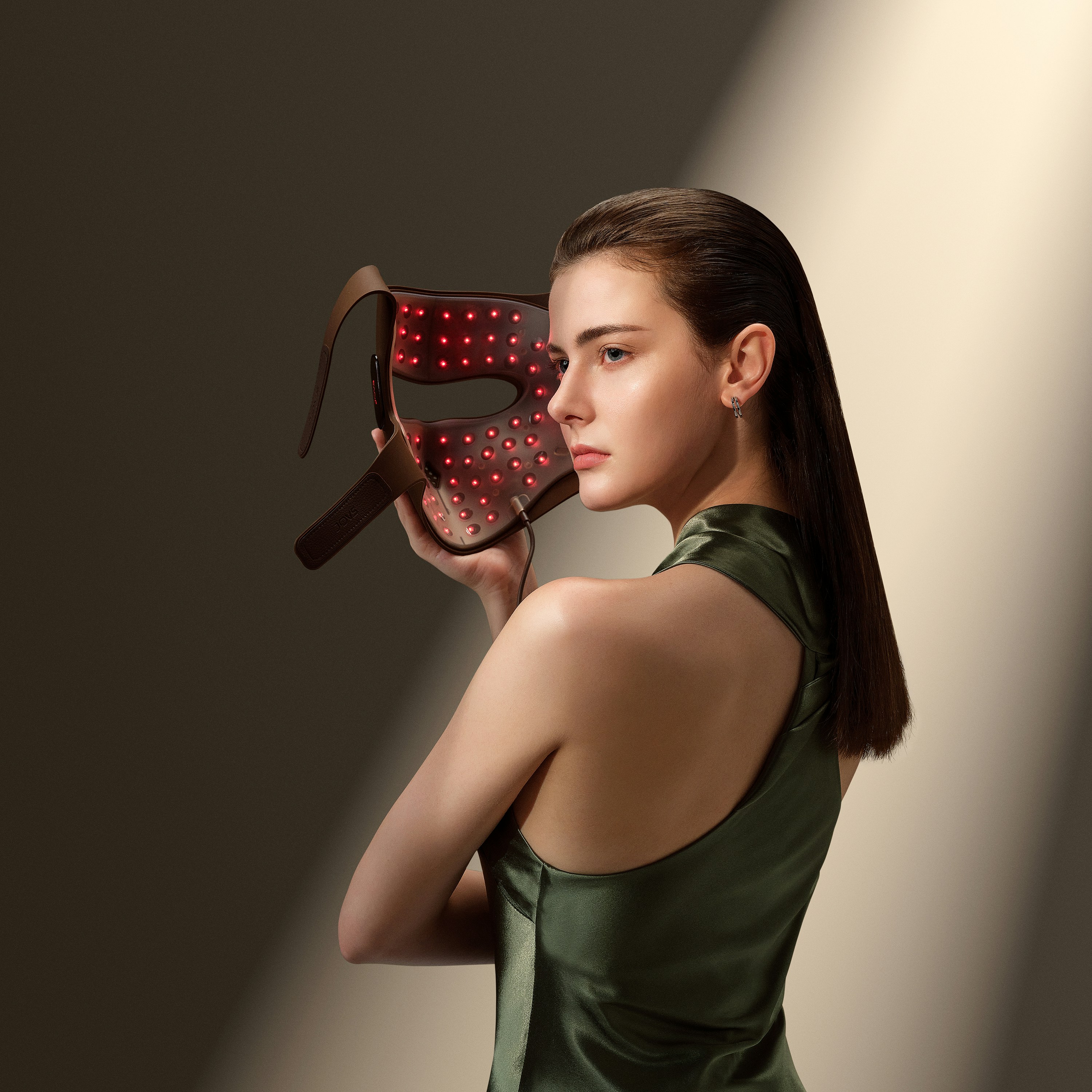 a woman in a green dress holding a pair of glasses