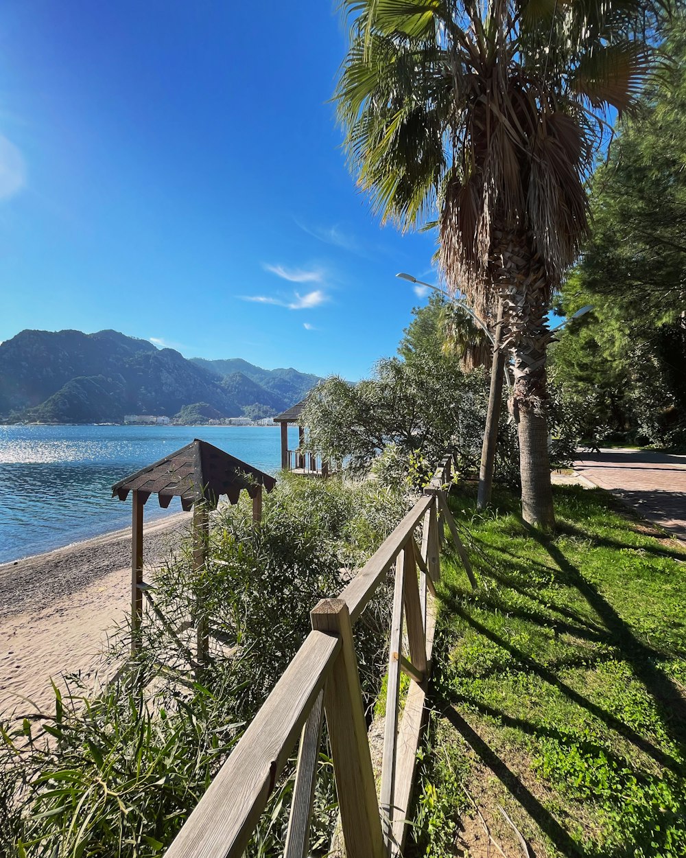 a wooden fence next to a body of water