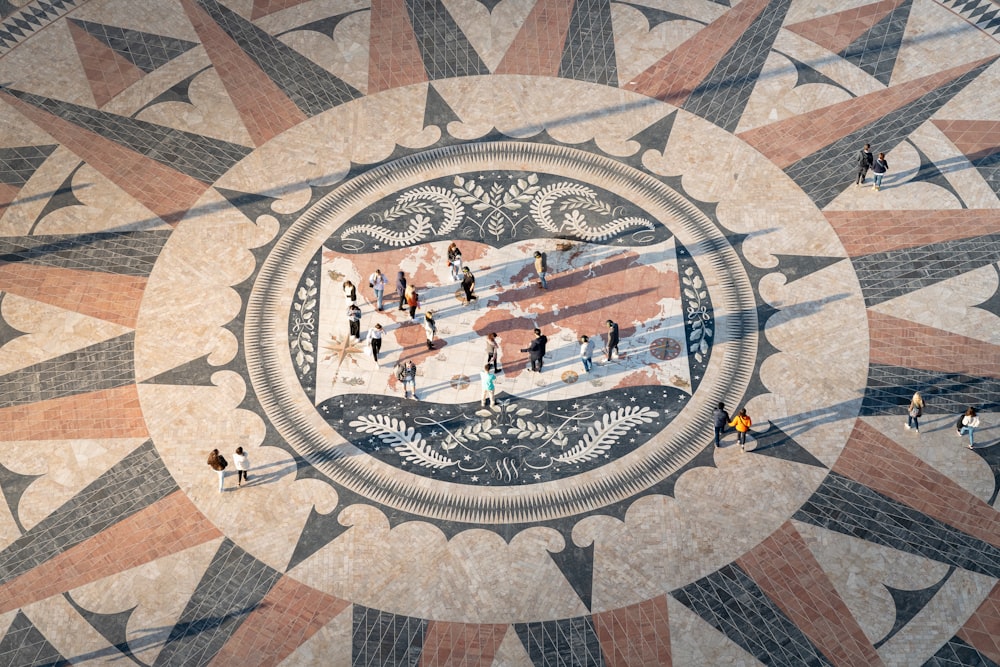 a large mosaic with people walking around it