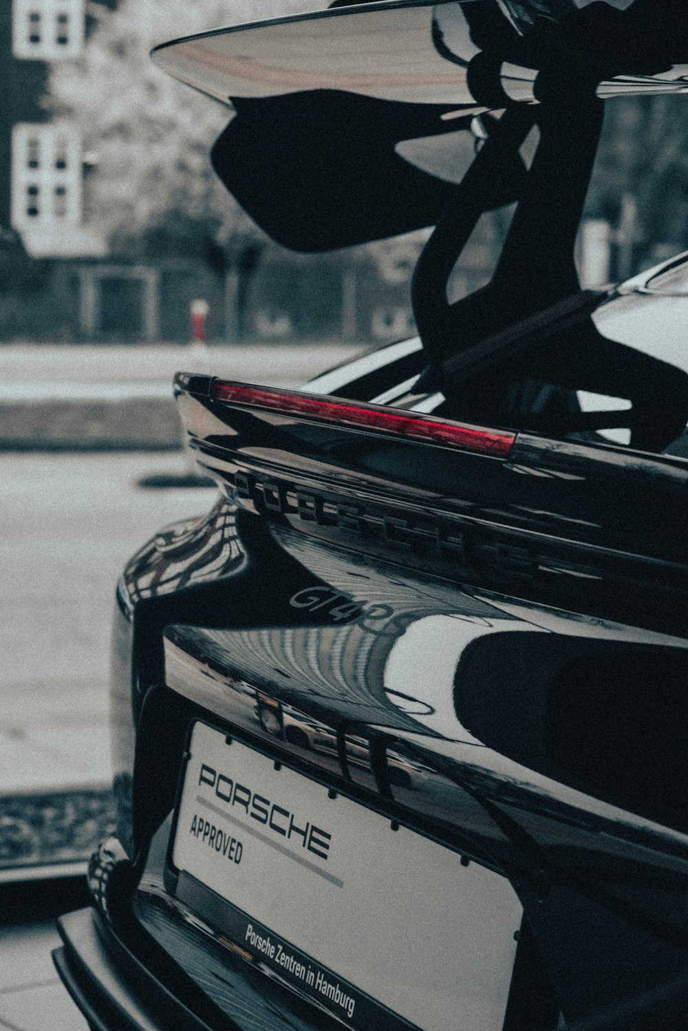 a porsche parked on the side of the road