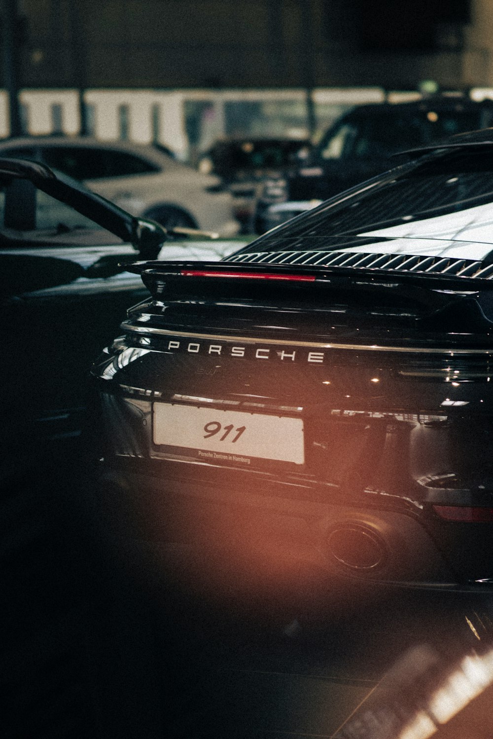 a black porsche parked on the side of the road