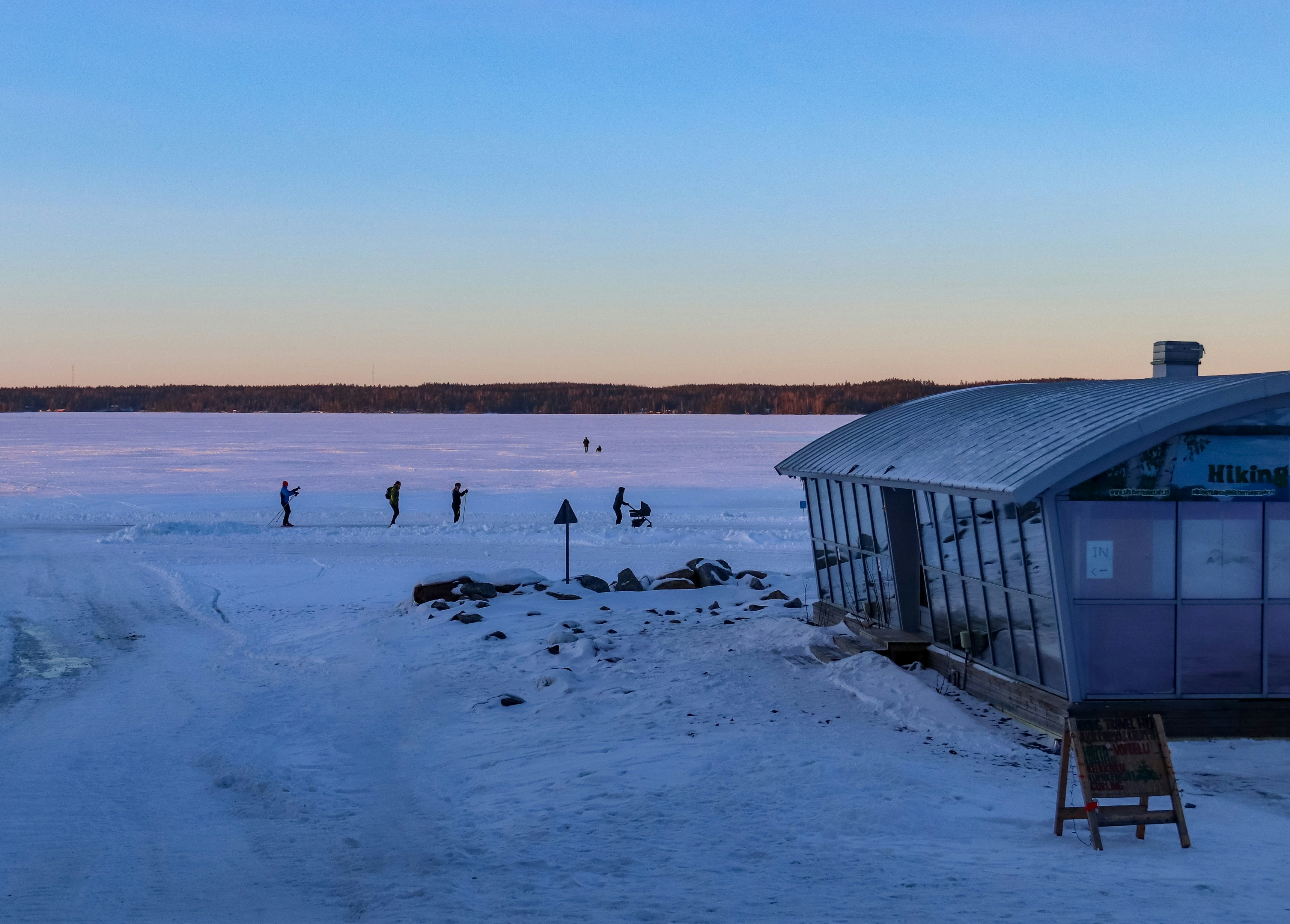 a group of people standing on top of a snow covered field