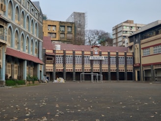 an empty parking lot with a building in the background