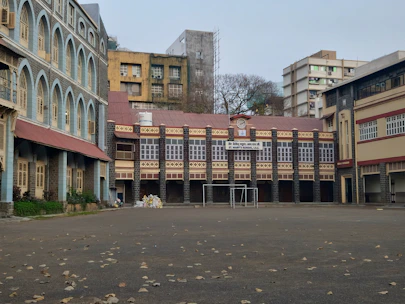 an empty parking lot with a building in the background