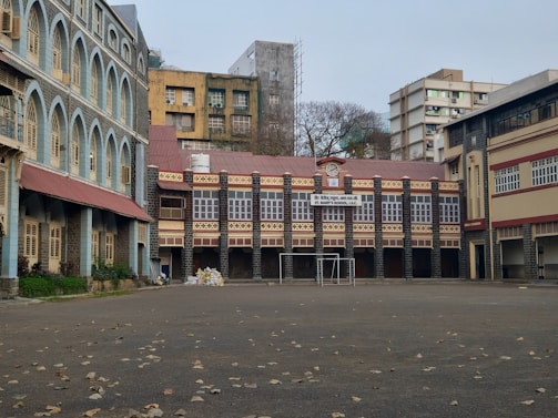 an empty parking lot with a building in the background
