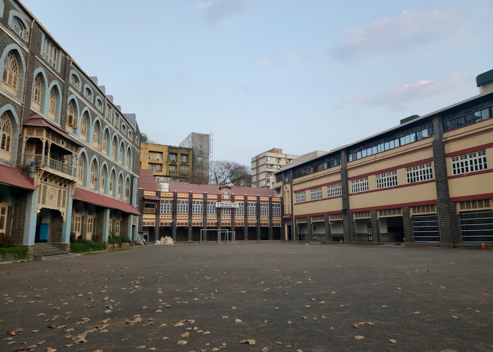 an empty parking lot in front of a row of buildings