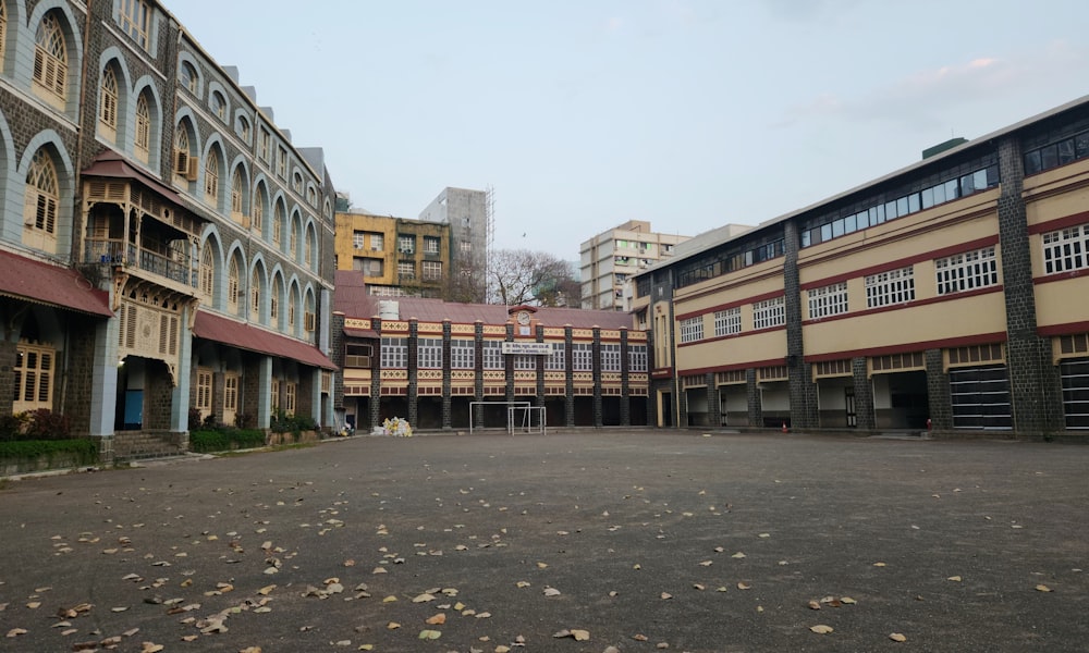 an empty parking lot in front of a row of buildings