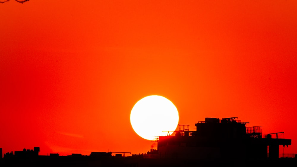 the sun is setting over a city skyline