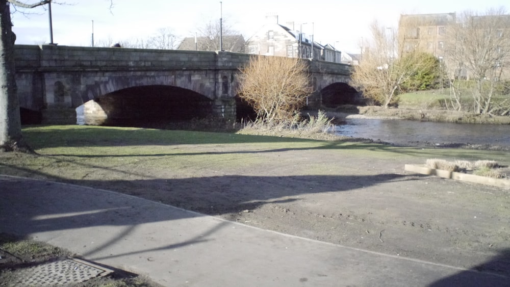 a bridge over a river next to a sidewalk