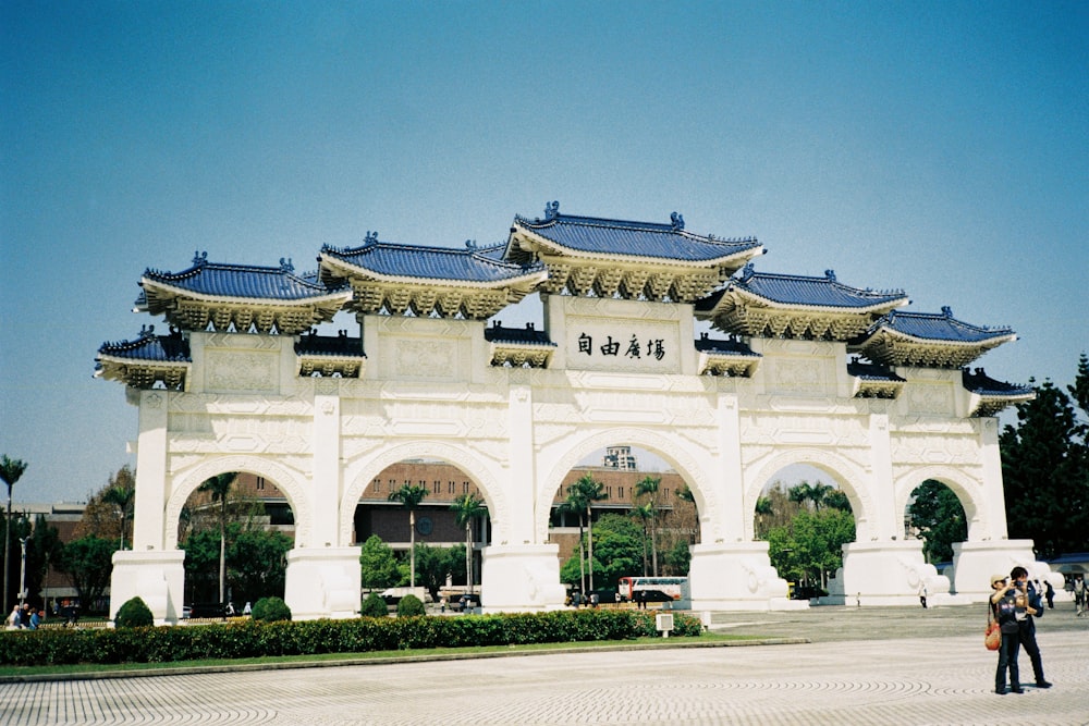 a large white building with blue roof tops