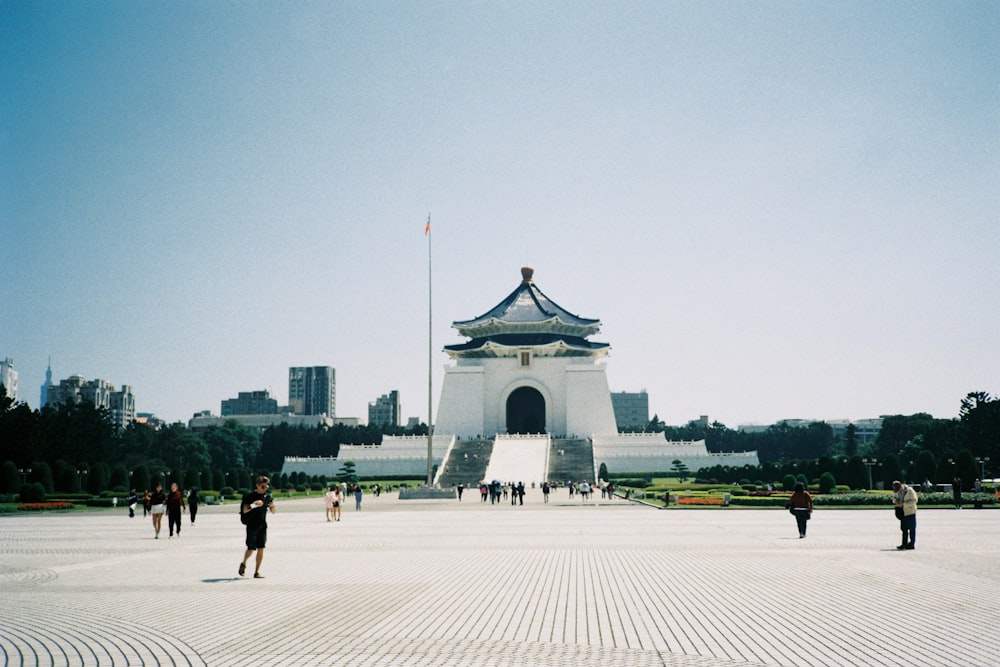 a group of people standing in front of a monument