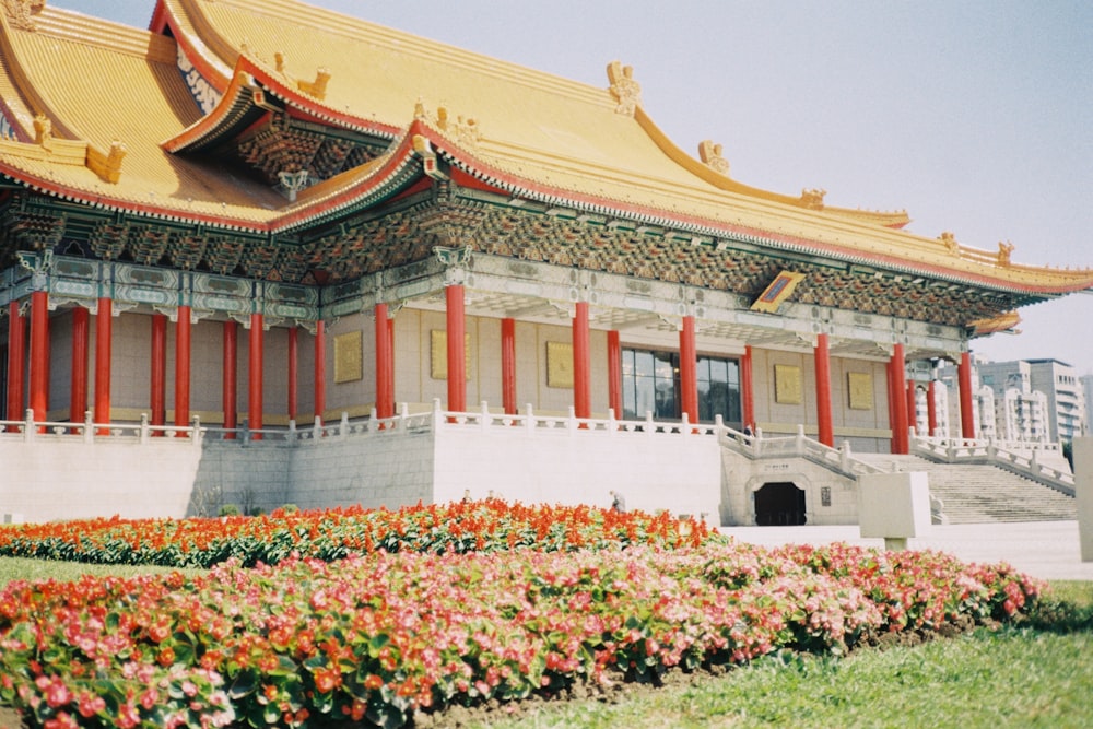 a building that has a lot of flowers in front of it