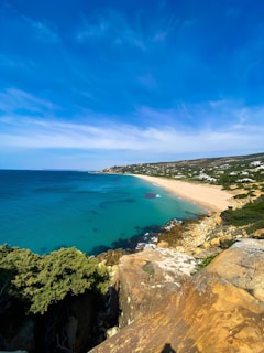 a view of a beach from a cliff