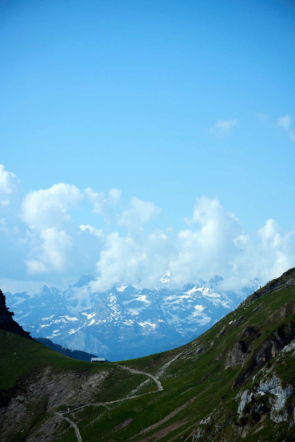 a view of a mountain range with clouds in the sky