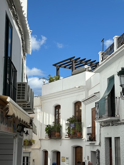 a man walking down a street next to tall buildings