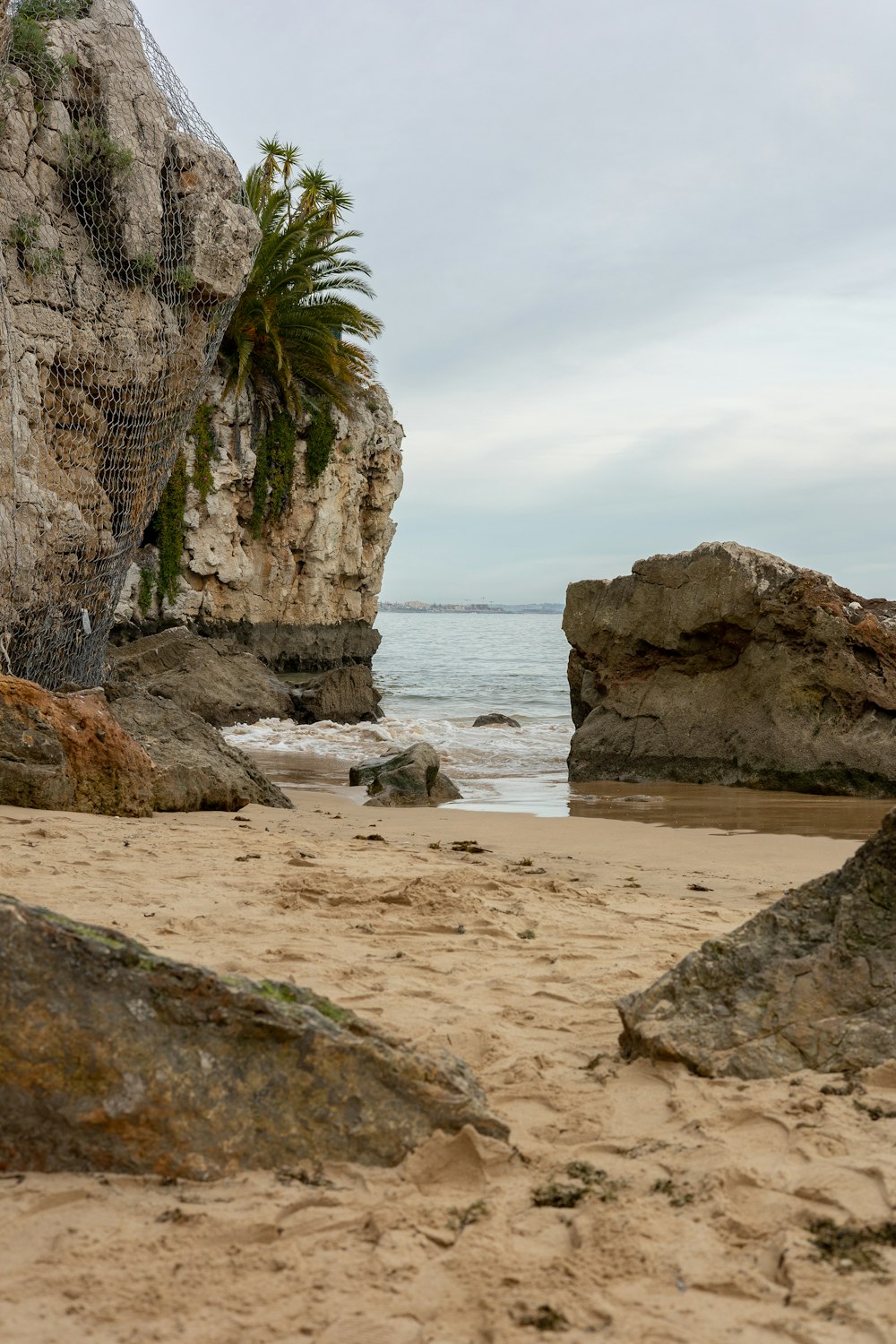 a view of the ocean from a sandy beach