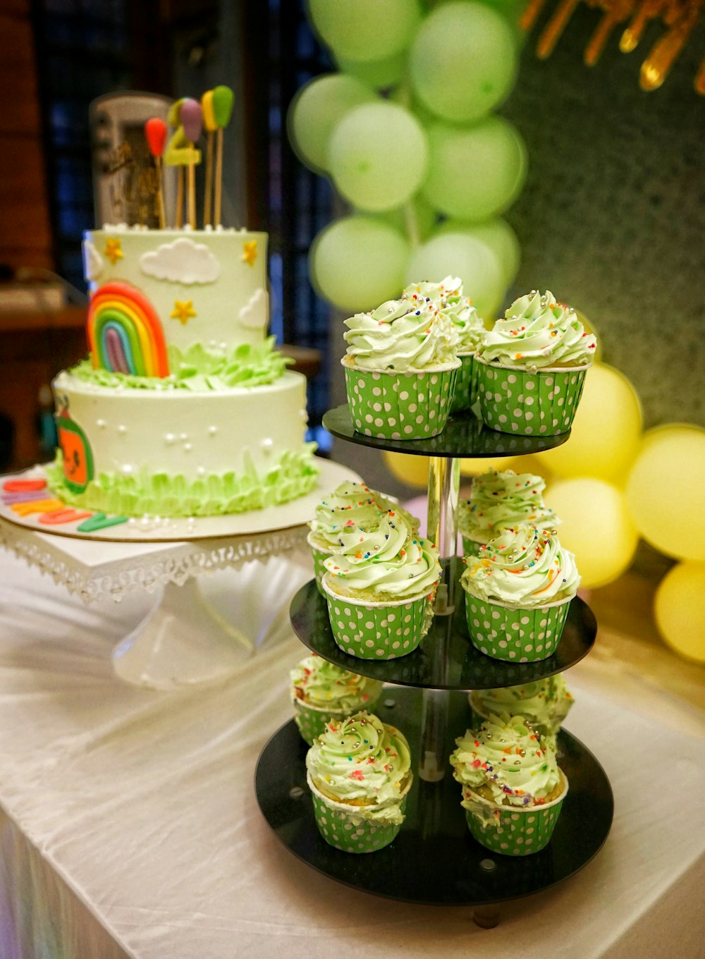 a table topped with cupcakes and a cake