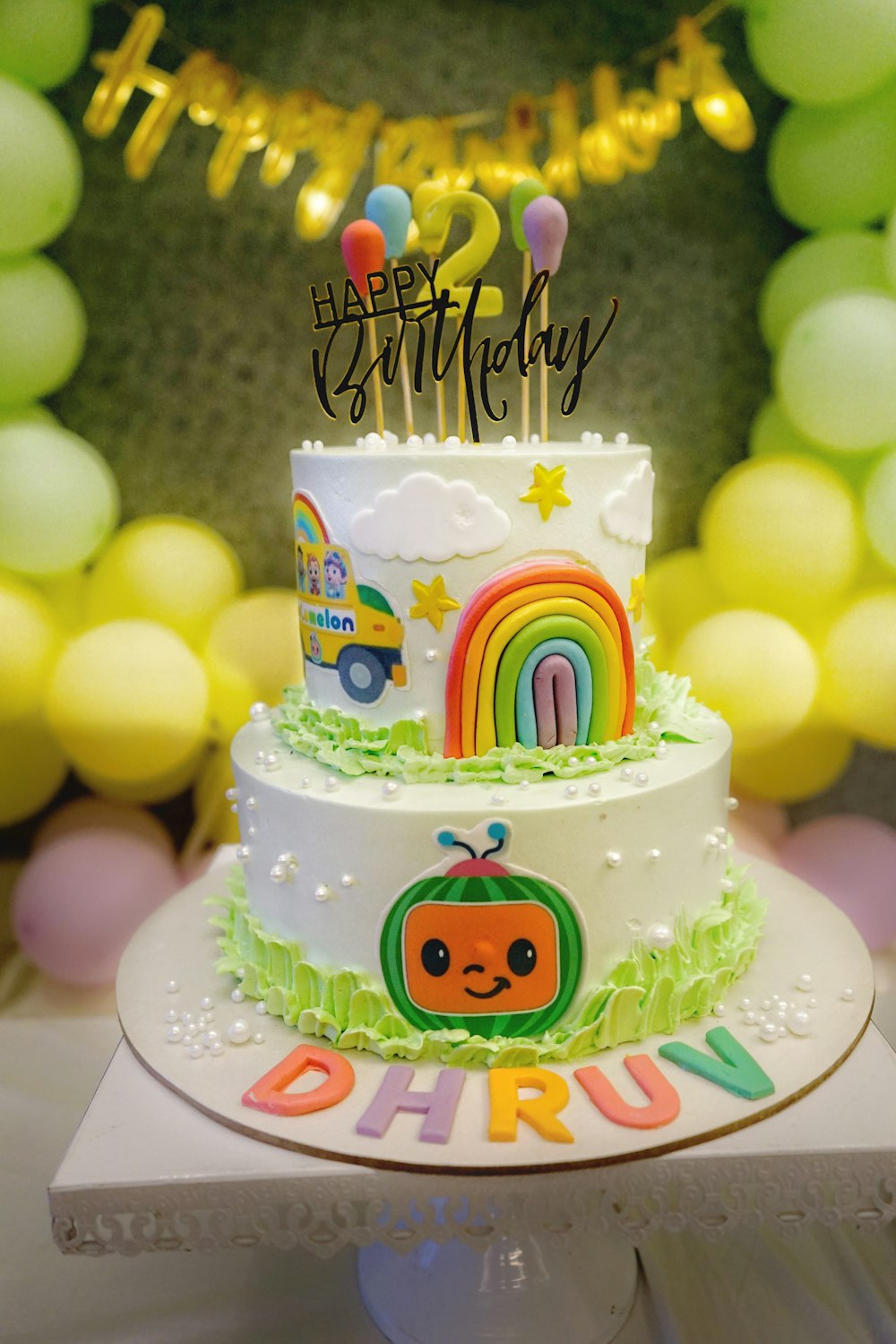 a birthday cake decorated with a rainbow theme