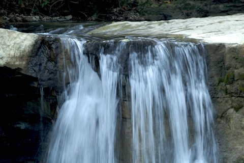 a large waterfall with water cascading down it's sides
