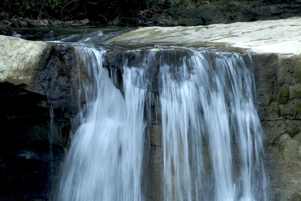 a large waterfall with water cascading down it's sides