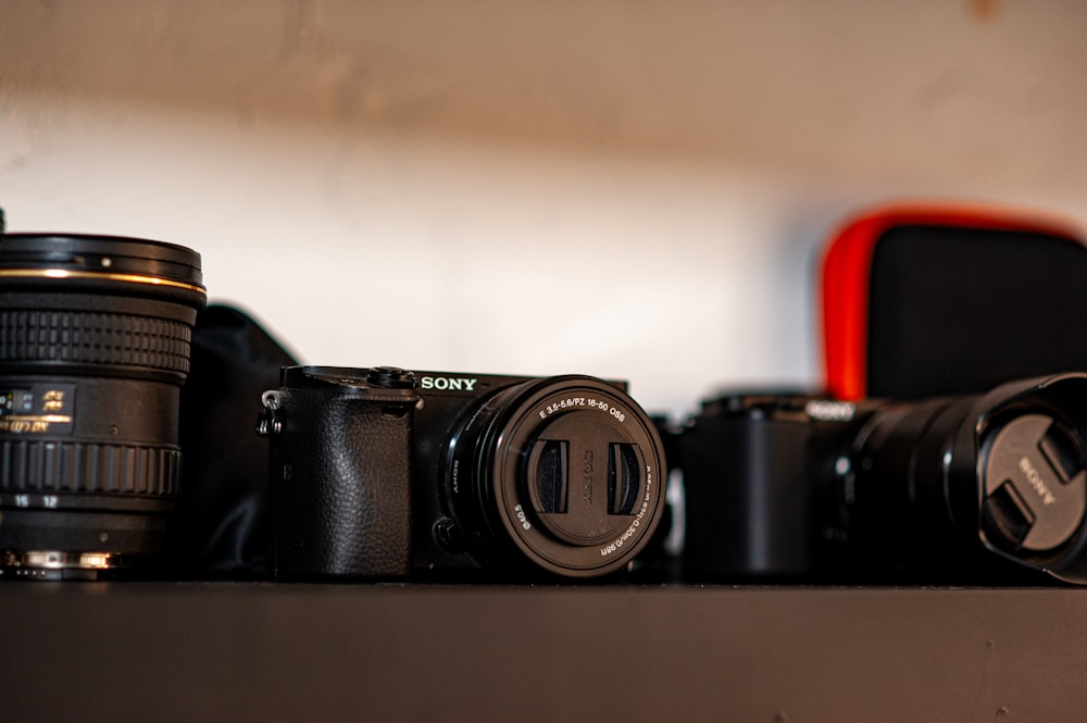 a couple of cameras sitting on top of a table