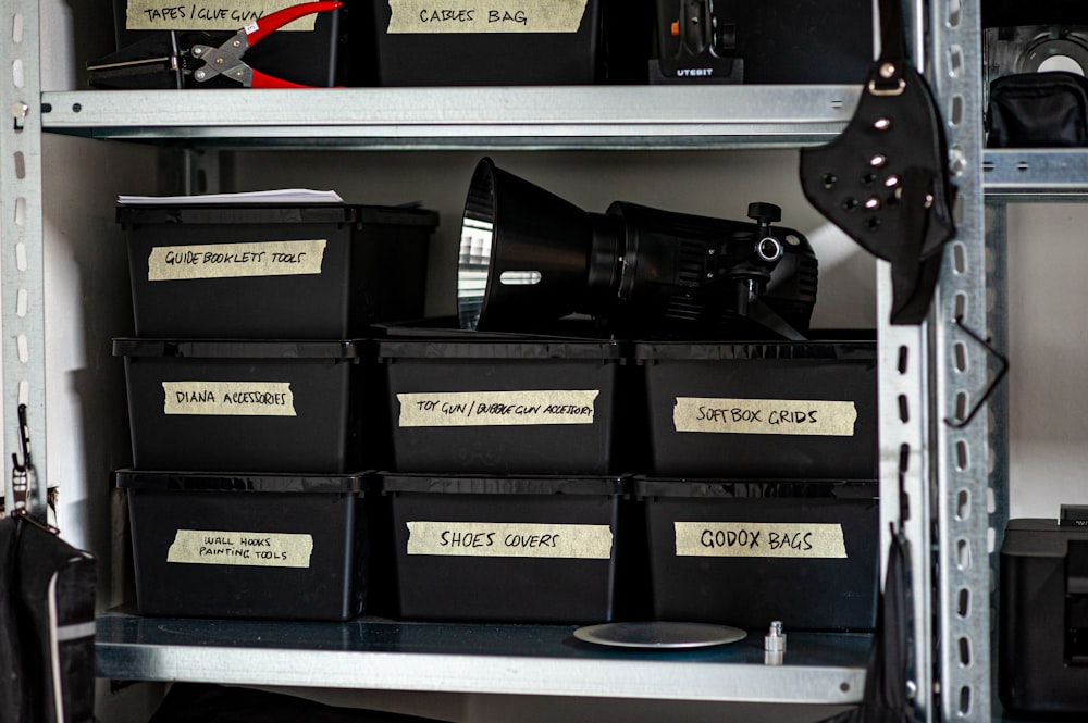 a shelf filled with lots of black boxes