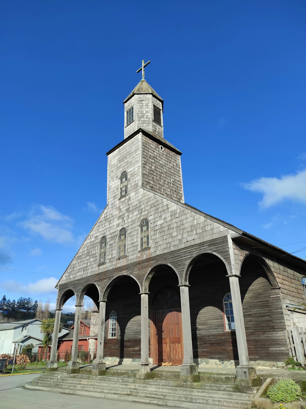 a church with a steeple and a cross on top